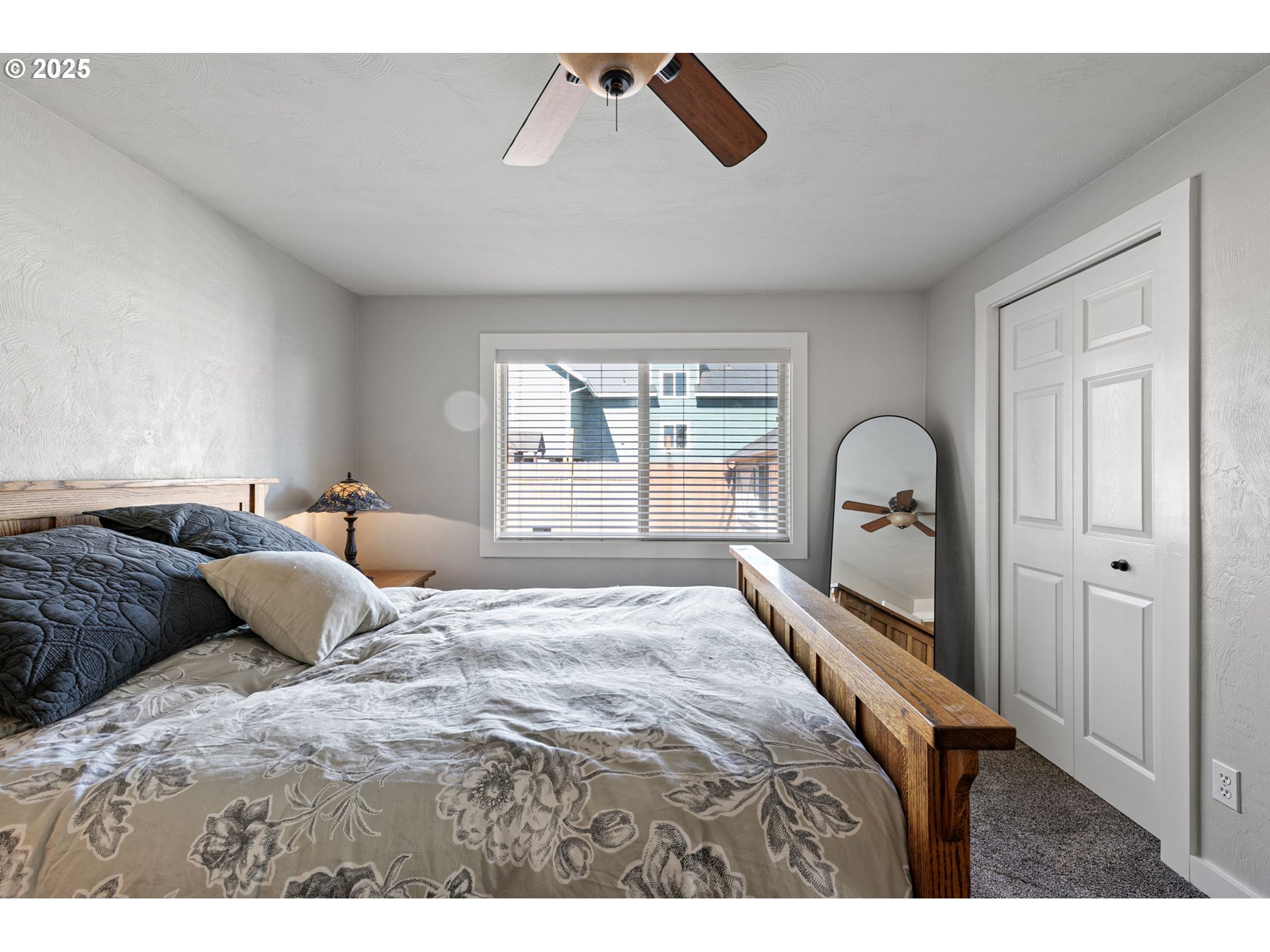 1011 Rose Street Junction City, OR 97448 - Photo 24 of 44 a bedroom with a large bed and a large window