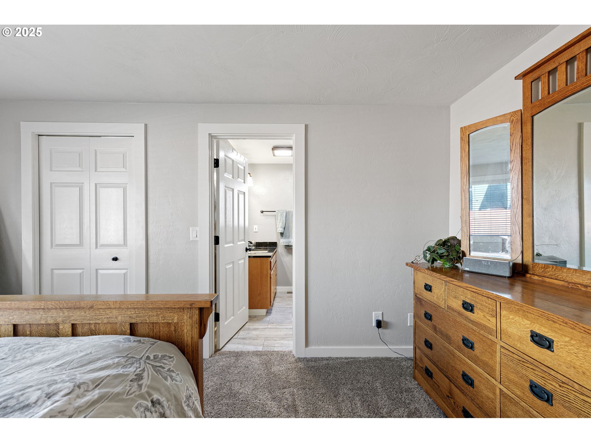 1011 Rose Street Junction City, OR 97448 - Photo 25 of 44 a bedroom with a bed and a dresser