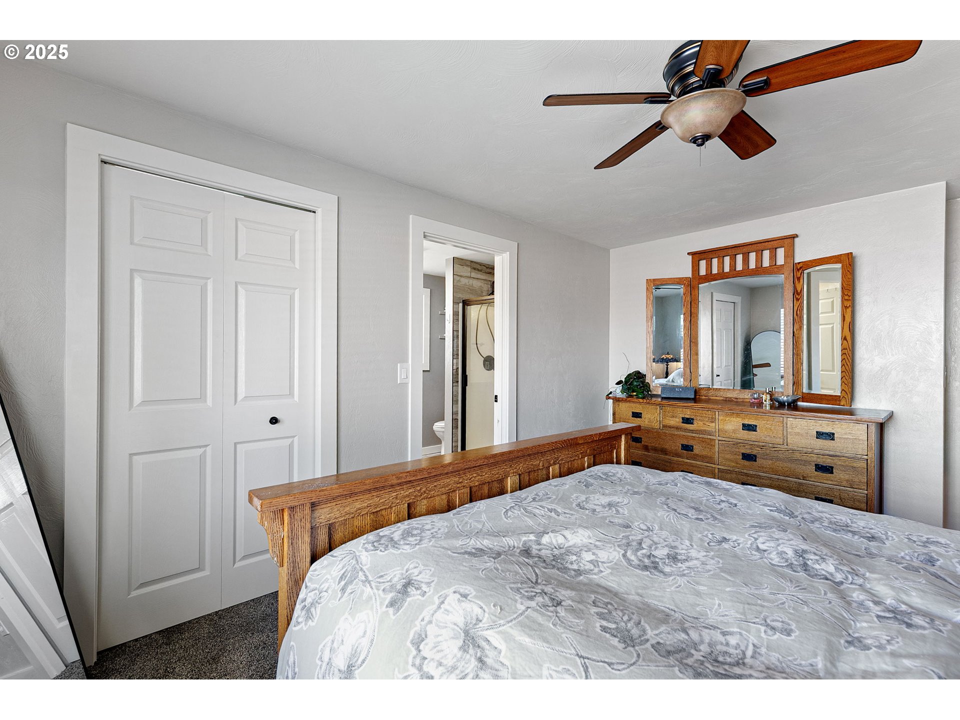 1011 Rose Street Junction City, OR 97448 - Photo 26 of 44 a bedroom with a bed and a chandelier