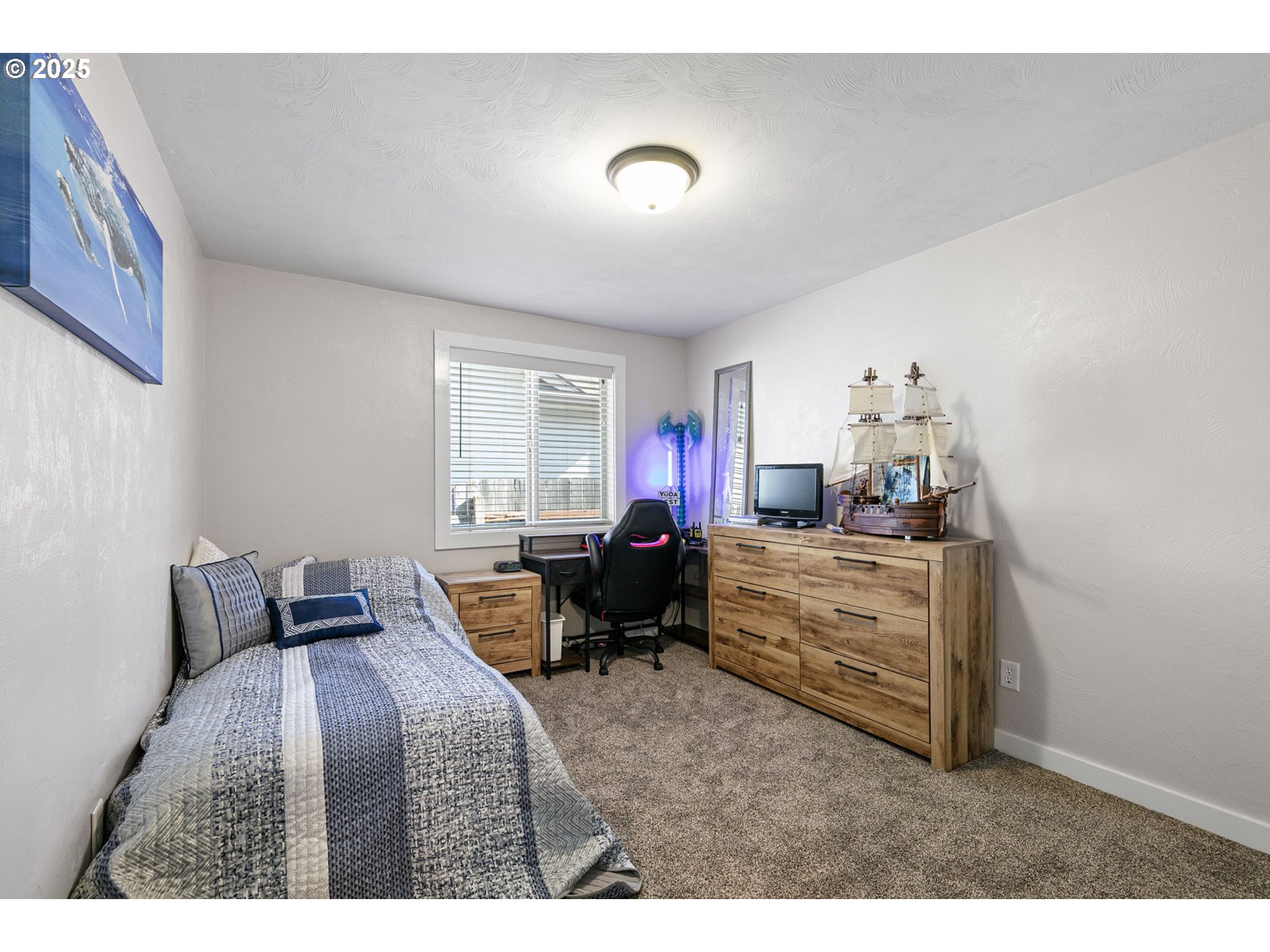 1011 Rose Street Junction City, OR 97448 - Photo 32 of 44 a bedroom with furniture and a window