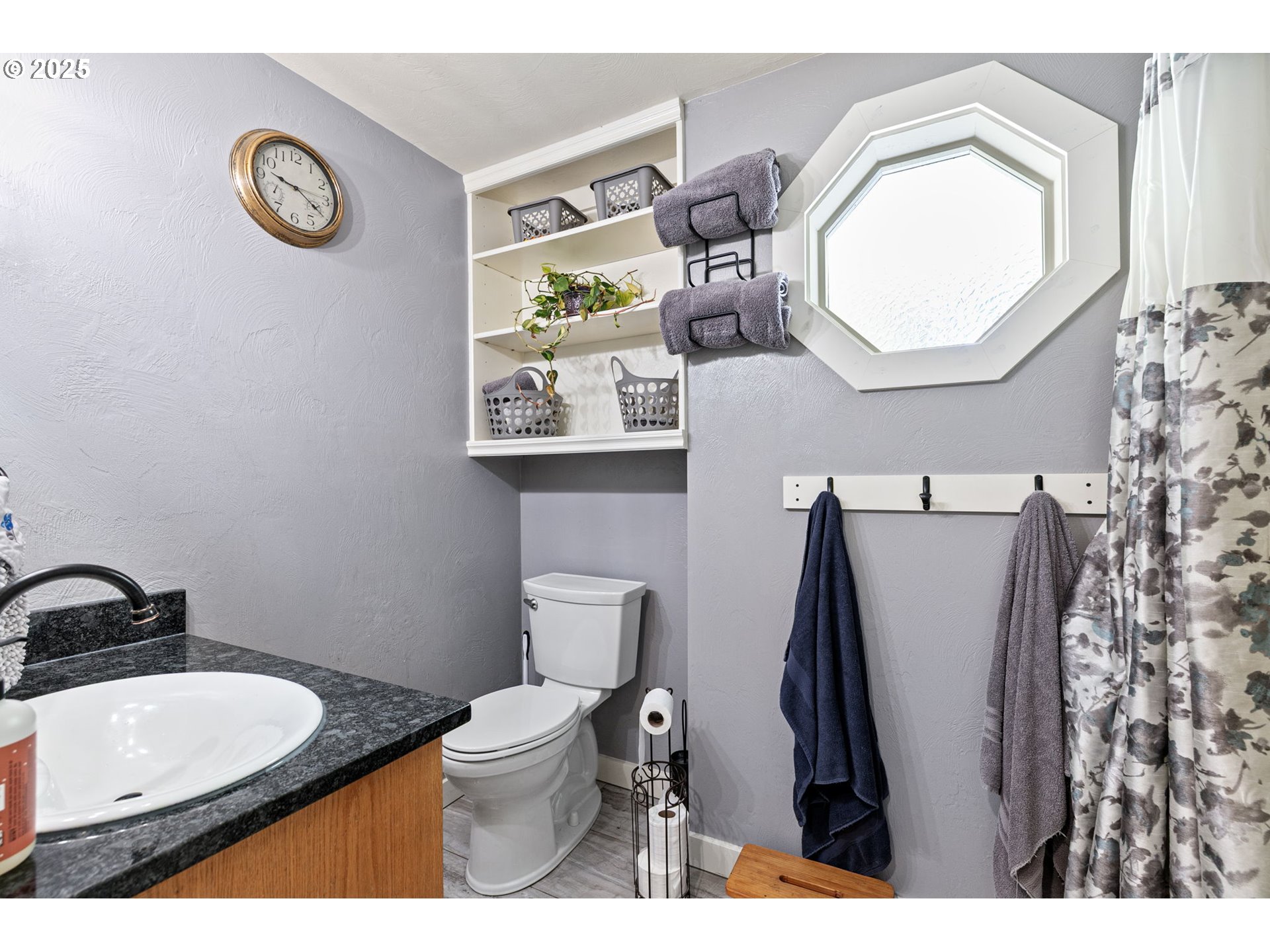 1011 Rose Street Junction City, OR 97448 - Photo 34 of 44 a bathroom with a toilet sink vanity and mirror