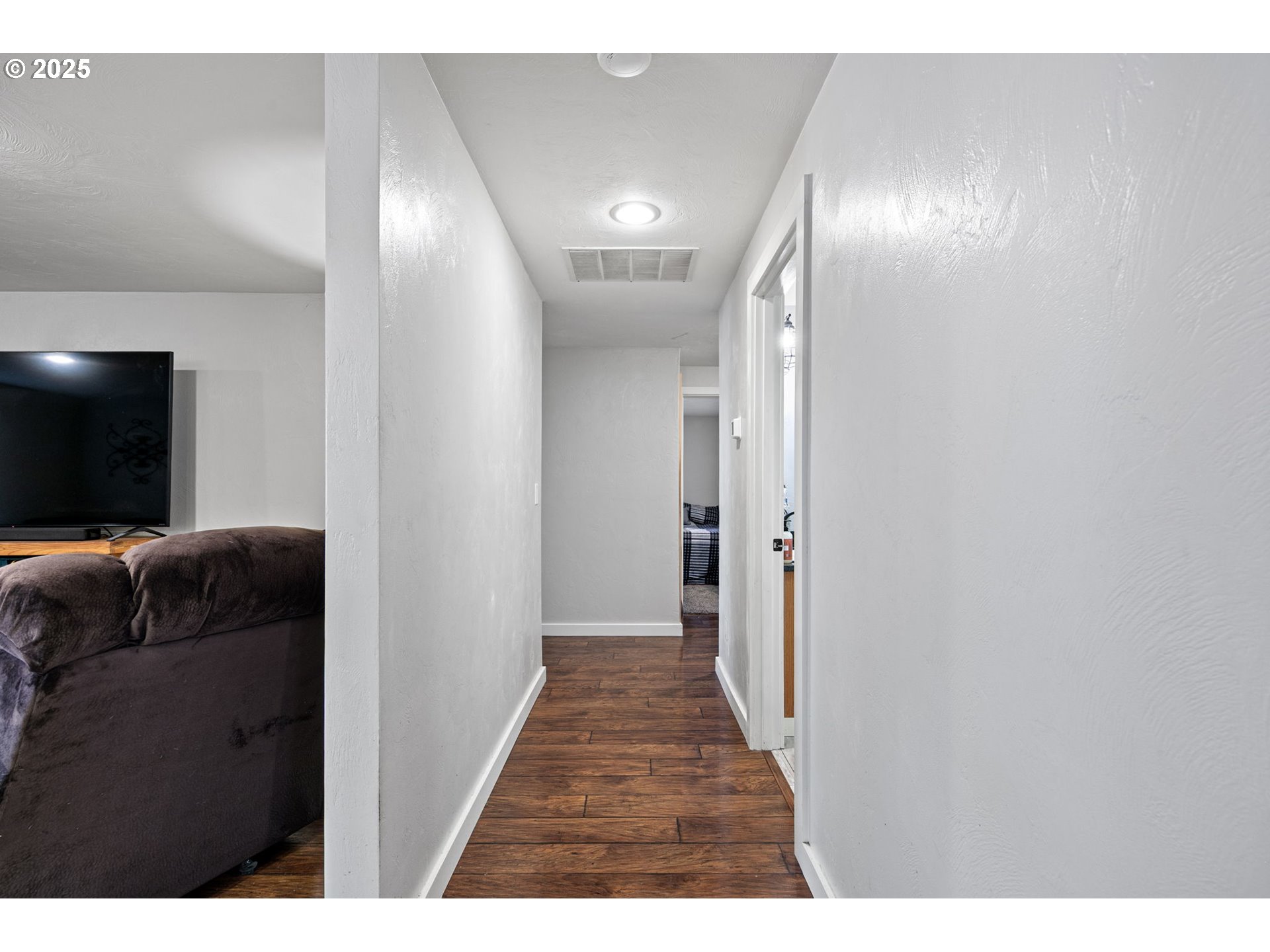 1011 Rose Street Junction City, OR 97448 - Photo 7 of 44 a view of a hallway with wooden floor