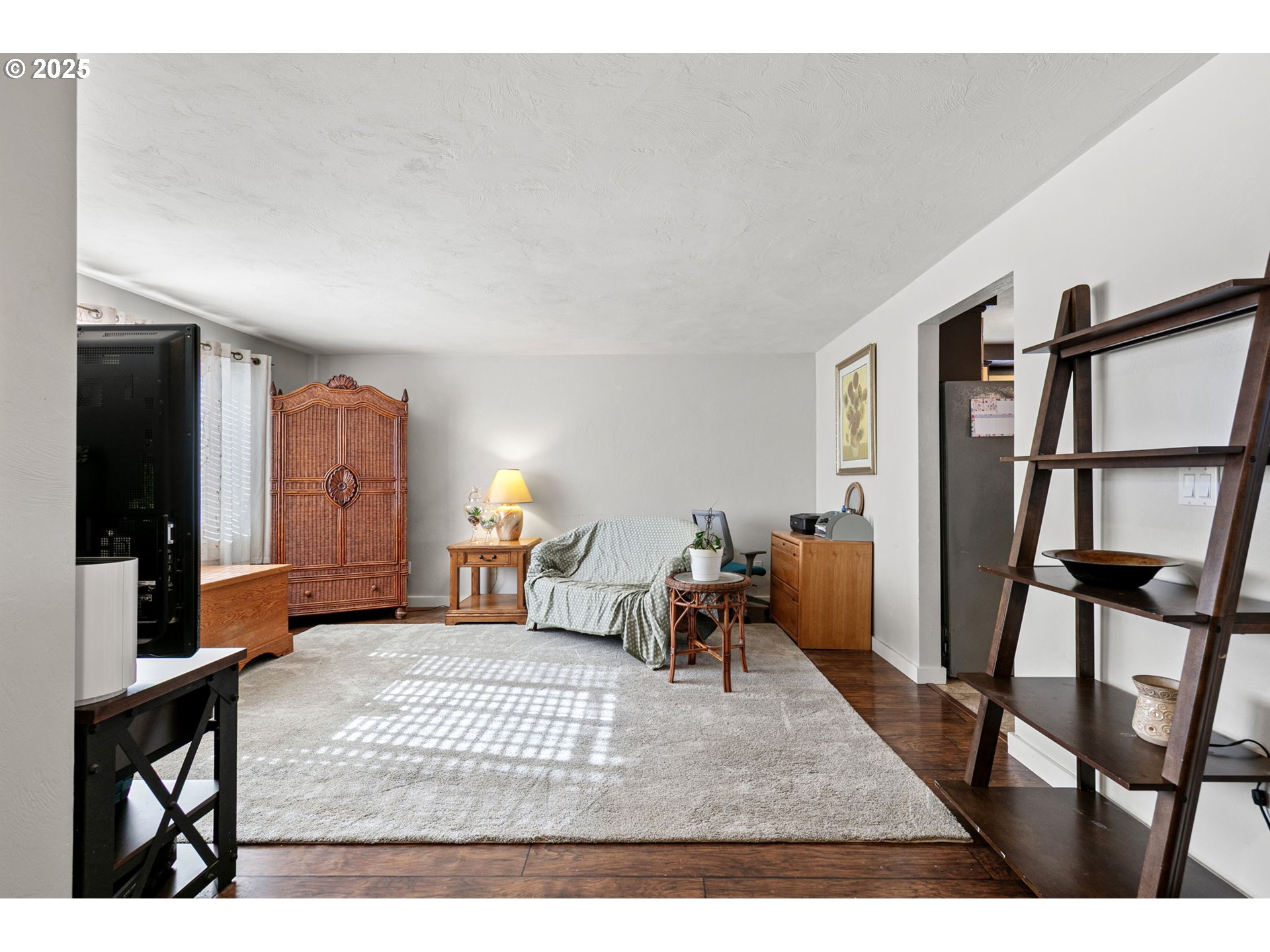 1011 Rose Street Junction City, OR 97448 - Photo 8 of 44 a living room with furniture and a flat screen tv