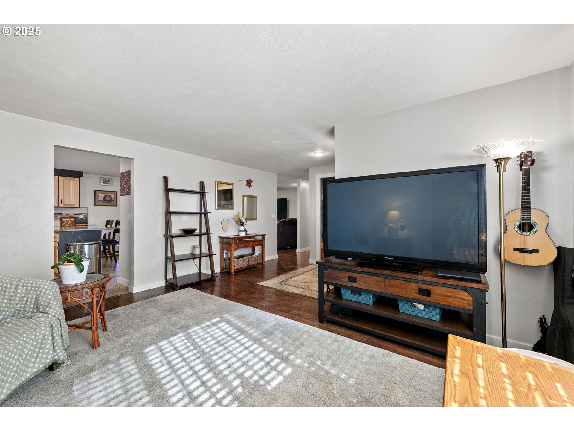1011 Rose Street Junction City, OR 97448 - Photo 10 of 44 a living room with furniture and a flat screen tv