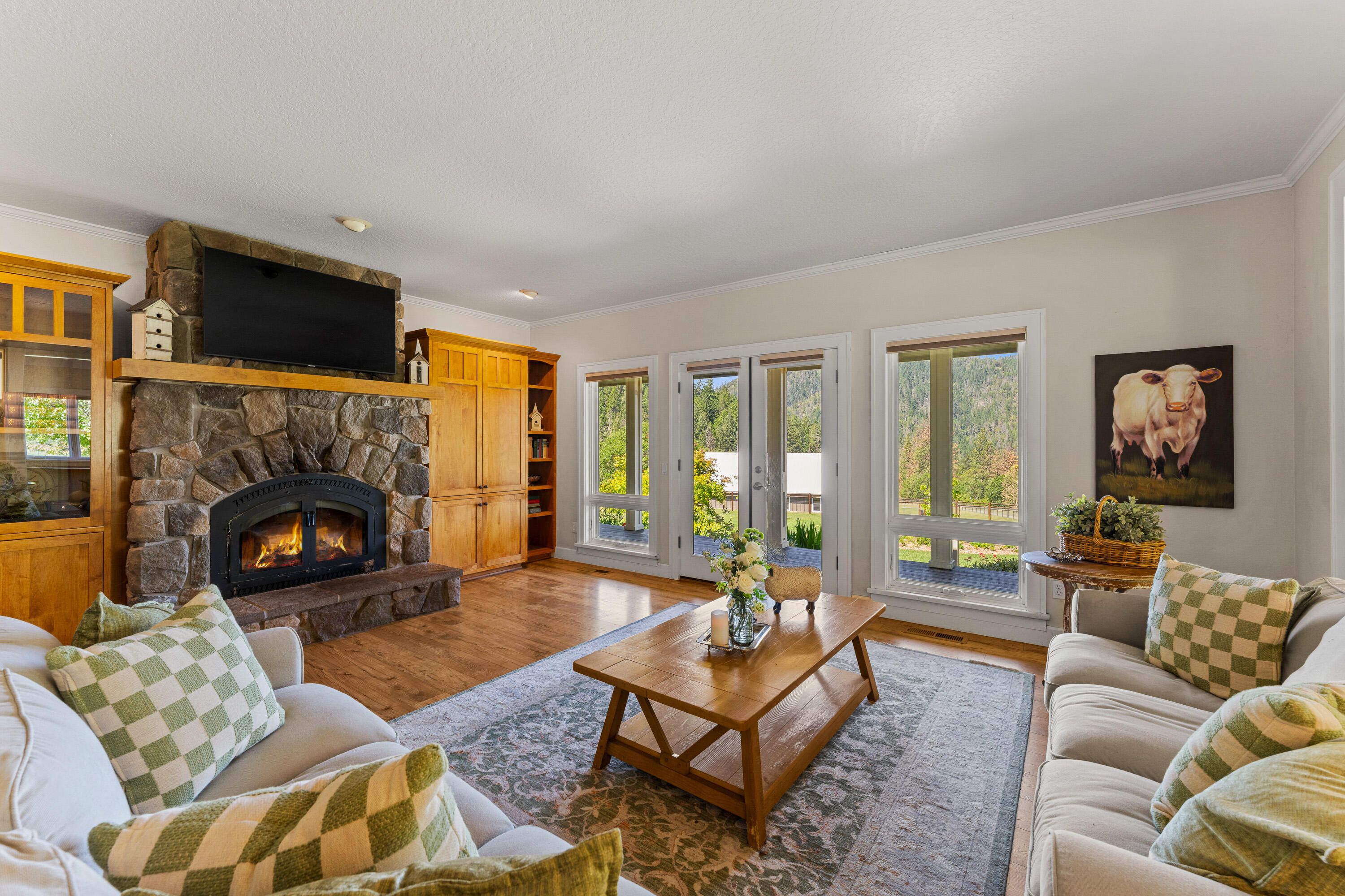 931 Hogan Road Jacksonville, OR 97530 - Photo 46 of 74 a living room with furniture a flat screen tv and a fireplace