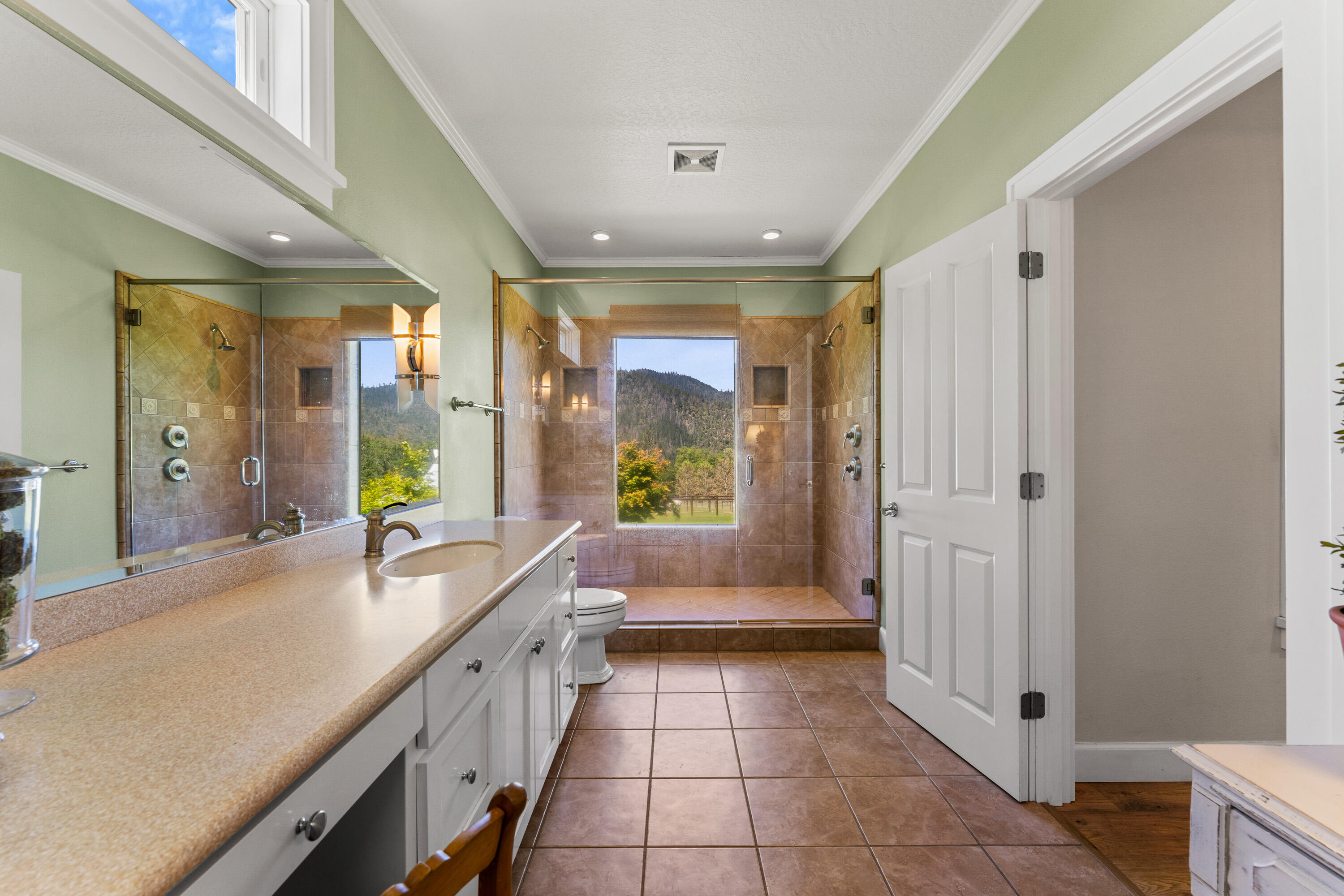 931 Hogan Road Jacksonville, OR 97530 - Photo 59 of 74 a large spacious bathroom with a double vanity sink a large mirror and a bathtub