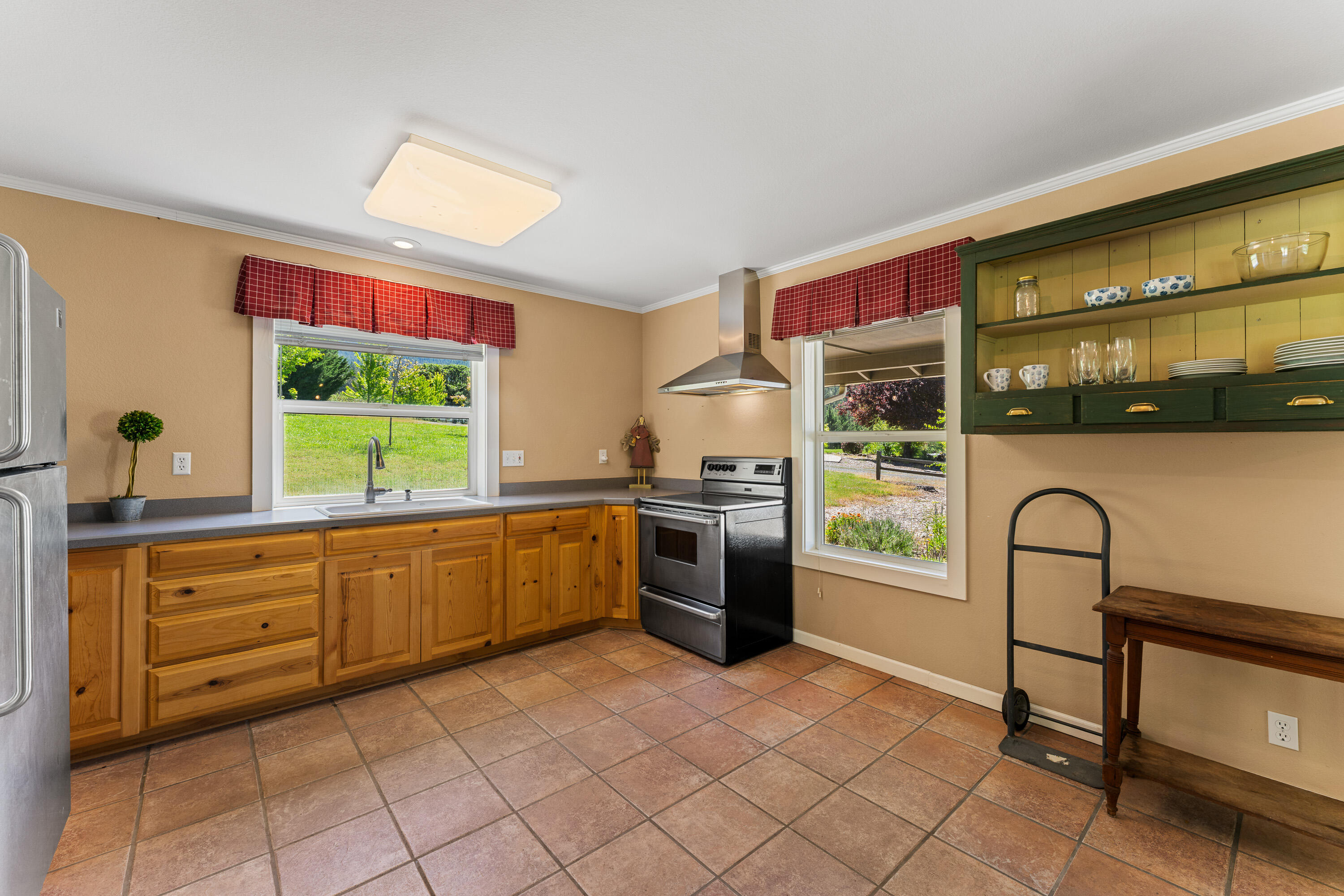 931 Hogan Road Jacksonville, OR 97530 - Photo 69 of 74 a kitchen with stainless steel appliances granite countertop a stove a sink and a refrigerator