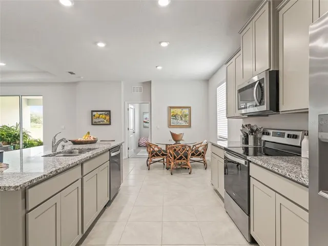 a kitchen with stainless steel appliances granite countertop a sink and cabinets