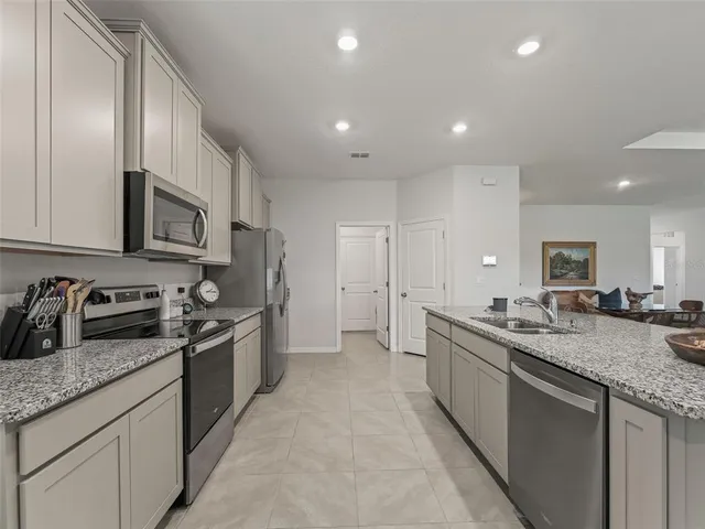 a kitchen with granite countertop stainless steel appliances and sink