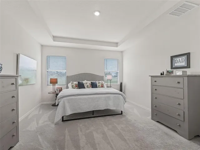 a room with a bed and a dresser