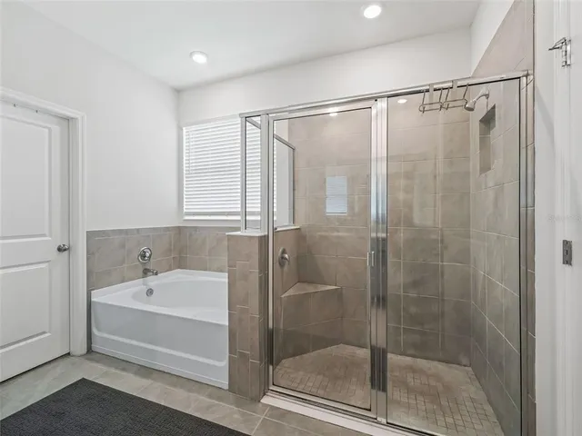 a bathroom with a bathtub and a shower