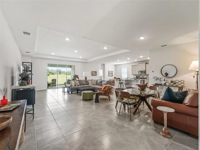 a living room with lots of furniture a rug and white walls