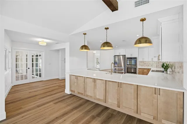 a view of empty room with wooden floor and windows