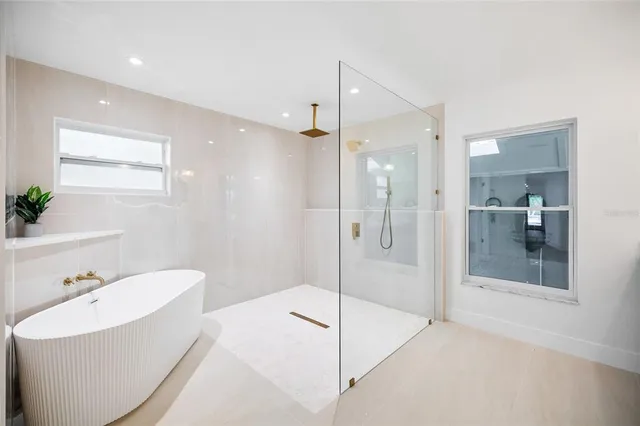 an empty room with ceiling fan and window