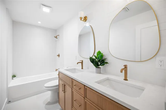 a spacious bedroom with a bed and a dresser