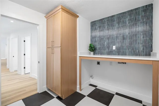 a kitchen with stove and cabinets