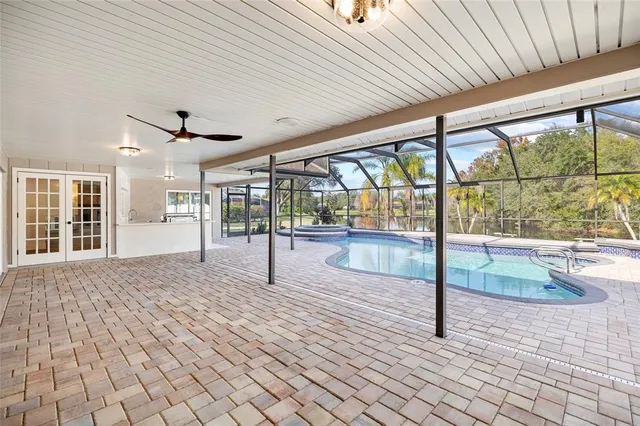 a view of a house with swimming pool and sitting area