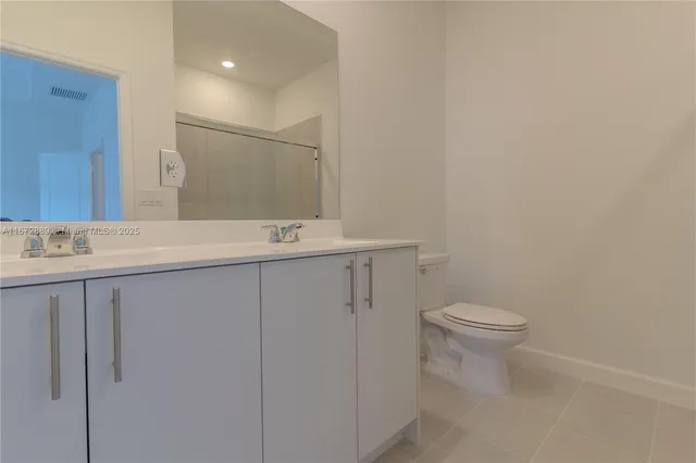 a bathroom with a sink toilet and mirror
