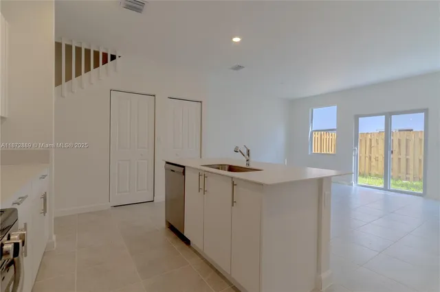 a view of a kitchen with a sink and a window