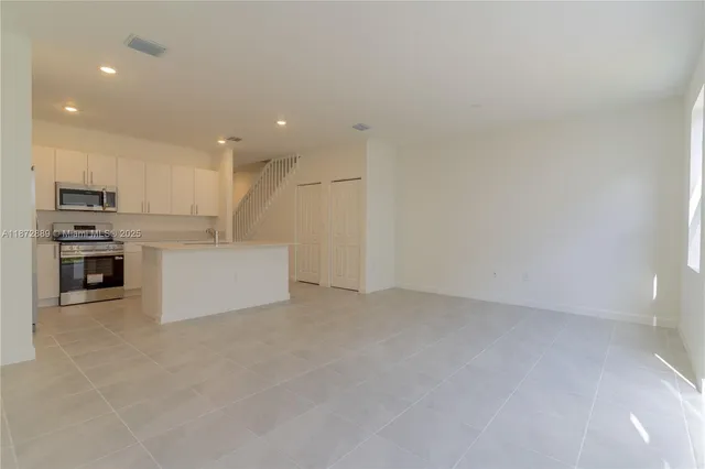 a view of a kitchen with a sink and an oven