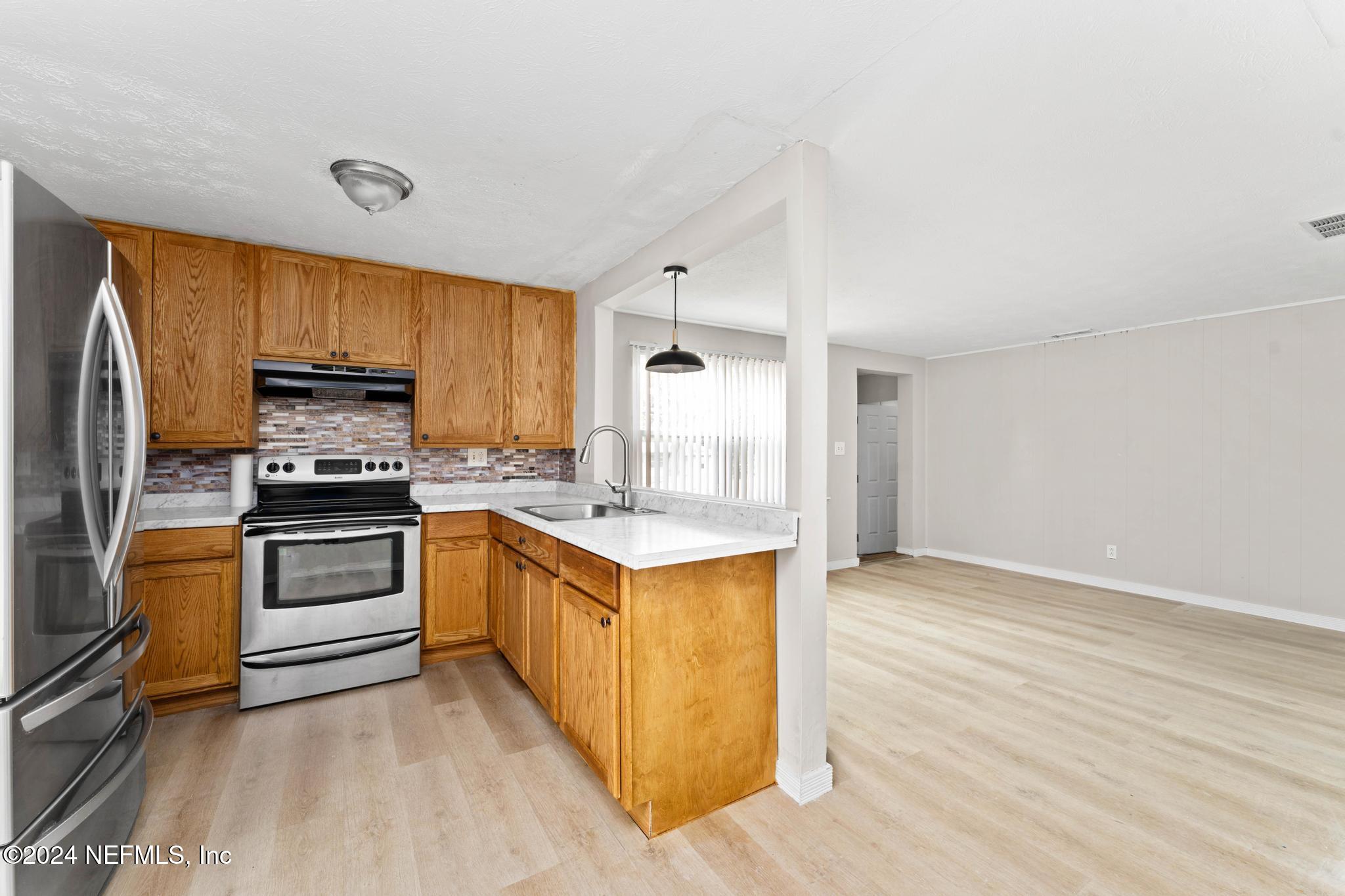 325 Toccoa Road Orange Park, FL 32073 - Photo 8 of 19 a kitchen with a stove a sink and a refrigerator