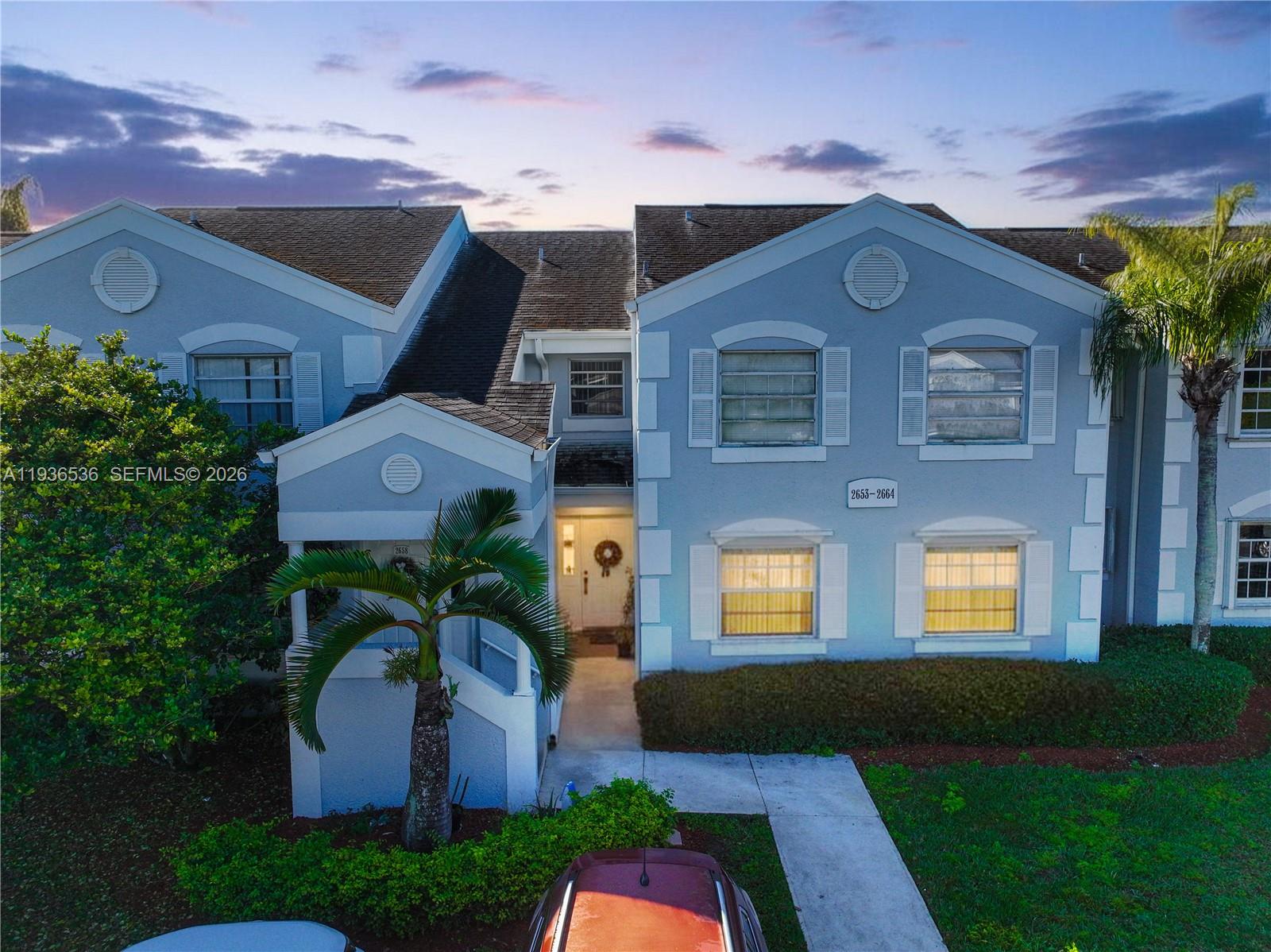 2657 Southeast 19th Court, Unit 103E Homestead, FL 33035 - Photo 1 of 50 a front view of a house with garden