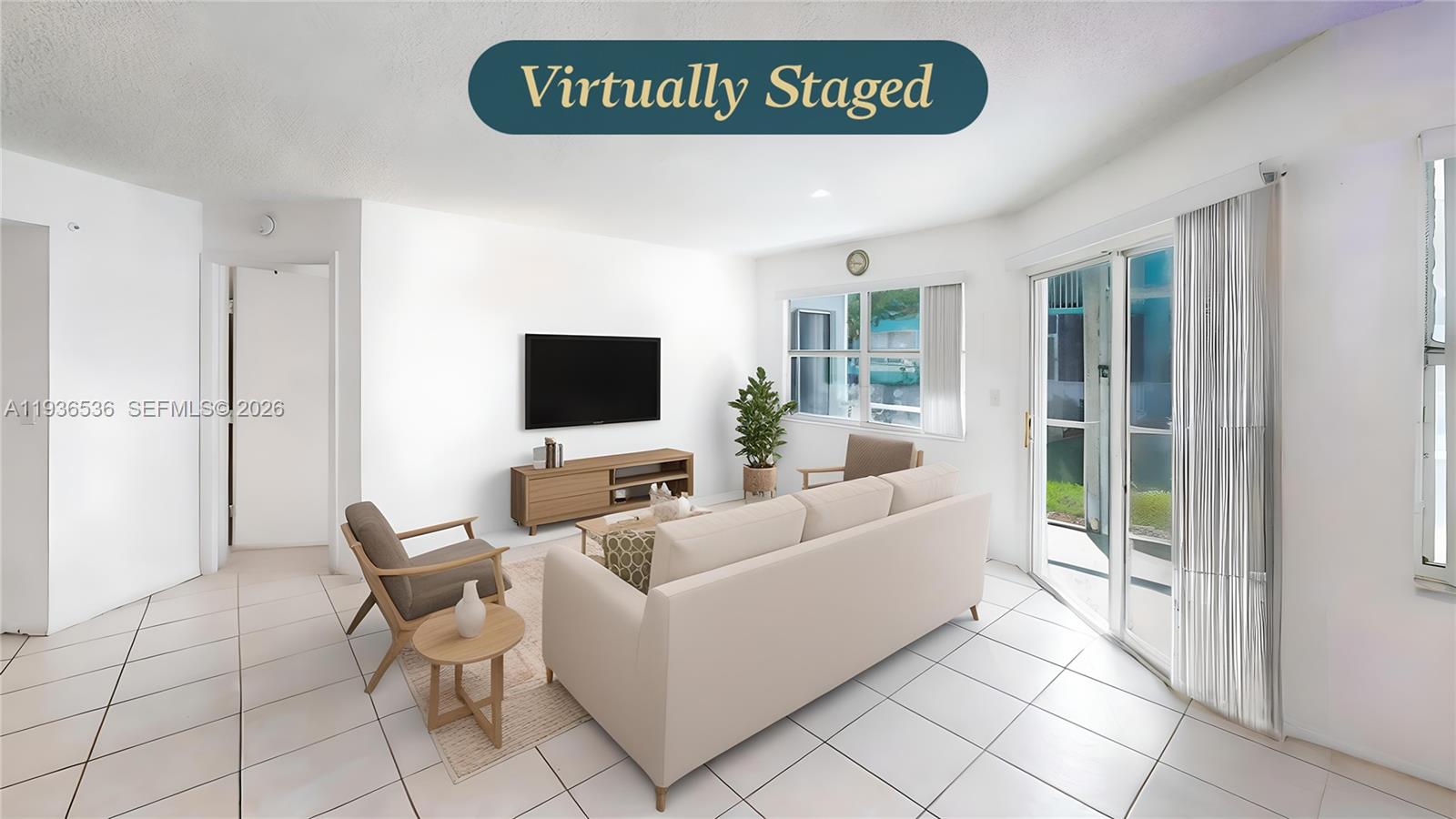 2657 Southeast 19th Court, Unit 103E Homestead, FL 33035 - Photo 11 of 50 a living room with furniture and a flat screen tv