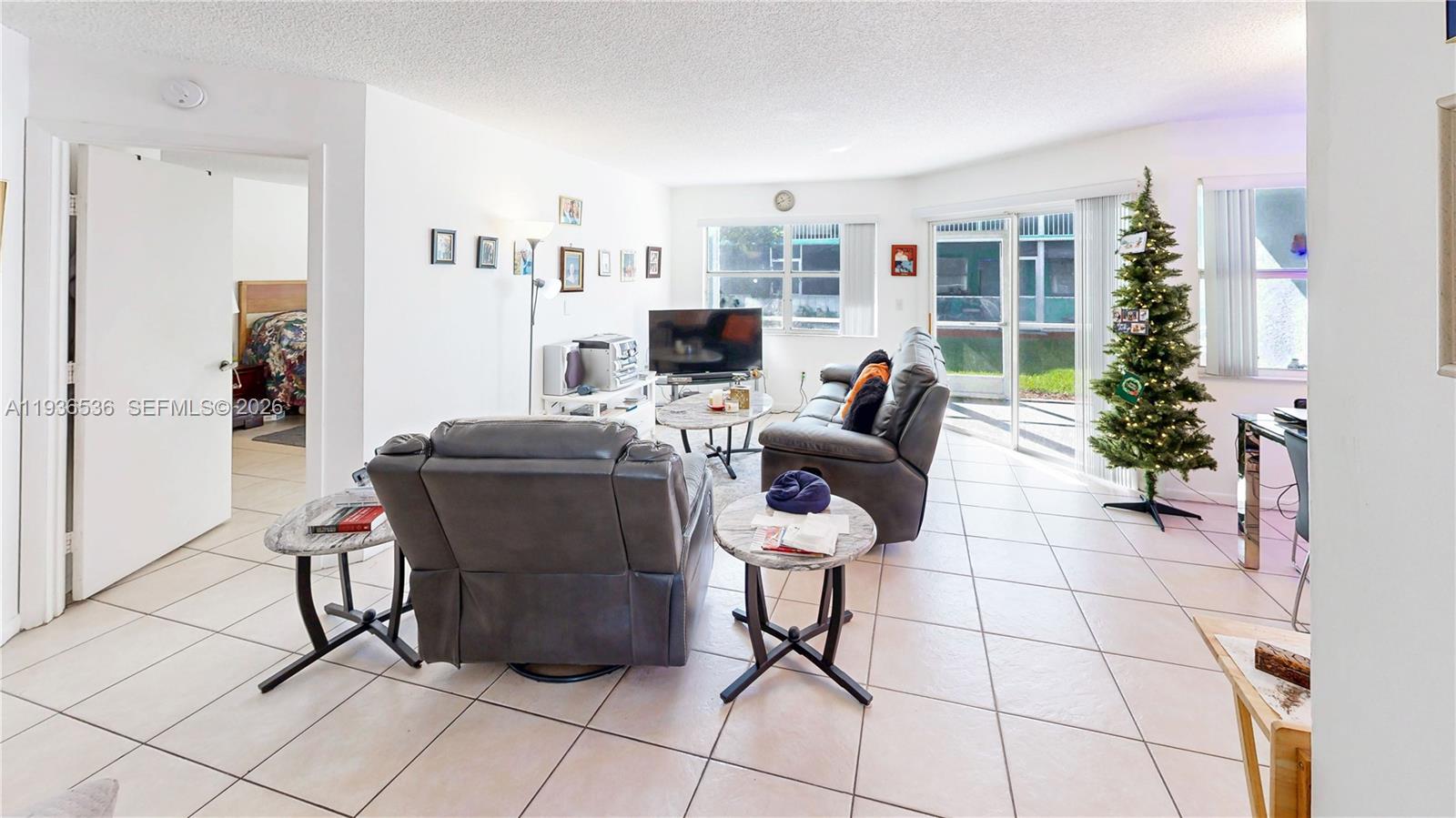 2657 Southeast 19th Court, Unit 103E Homestead, FL 33035 - Photo 12 of 50 a work room with furniture and a potted plant