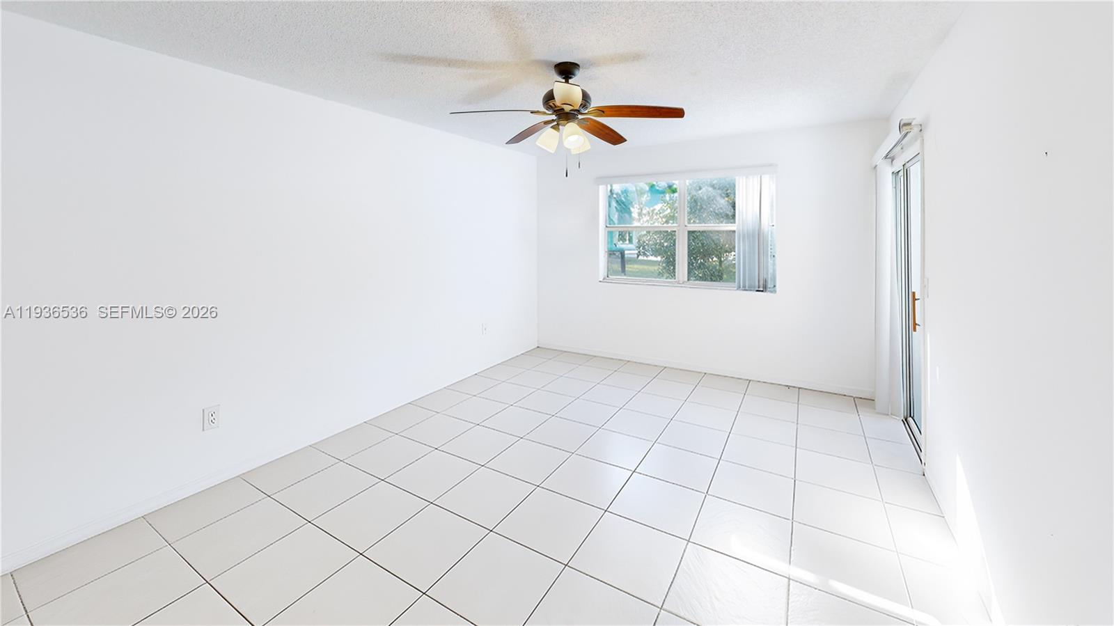 2657 Southeast 19th Court, Unit 103E Homestead, FL 33035 - Photo 16 of 50 a view of an empty room and a window