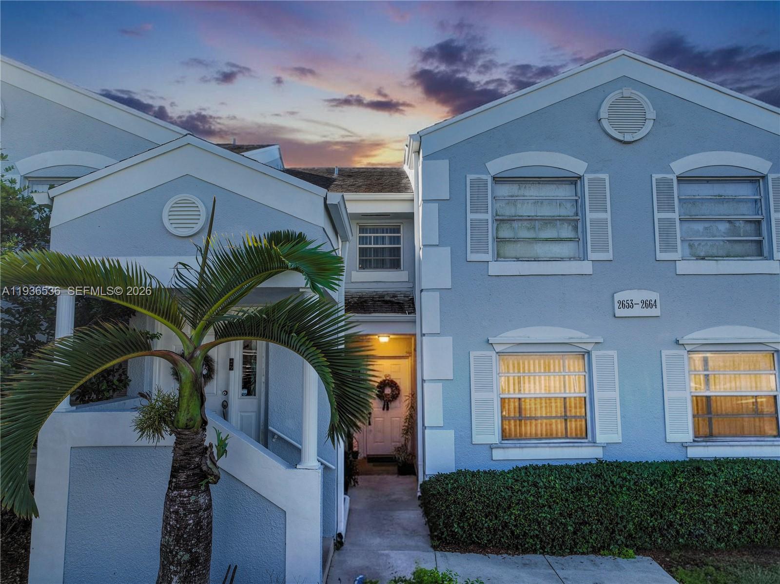 2657 Southeast 19th Court, Unit 103E Homestead, FL 33035 - Photo 2 of 50 a front view of a house with a yard
