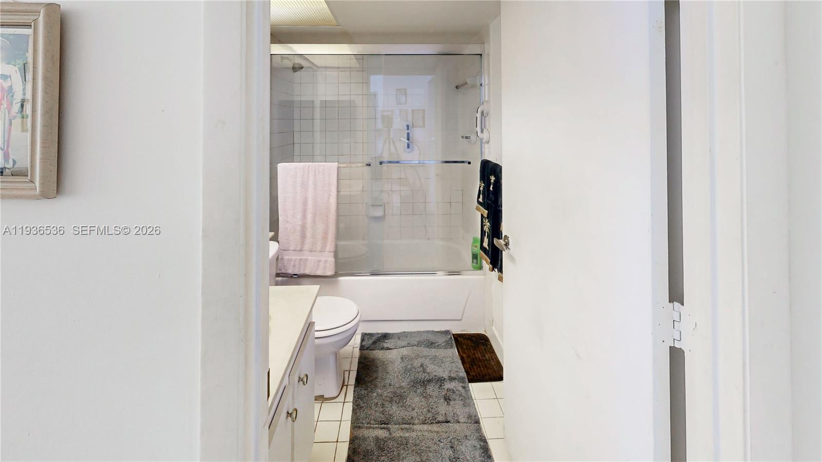 2657 Southeast 19th Court, Unit 103E Homestead, FL 33035 - Photo 23 of 50 a bathroom with a granite countertop shower