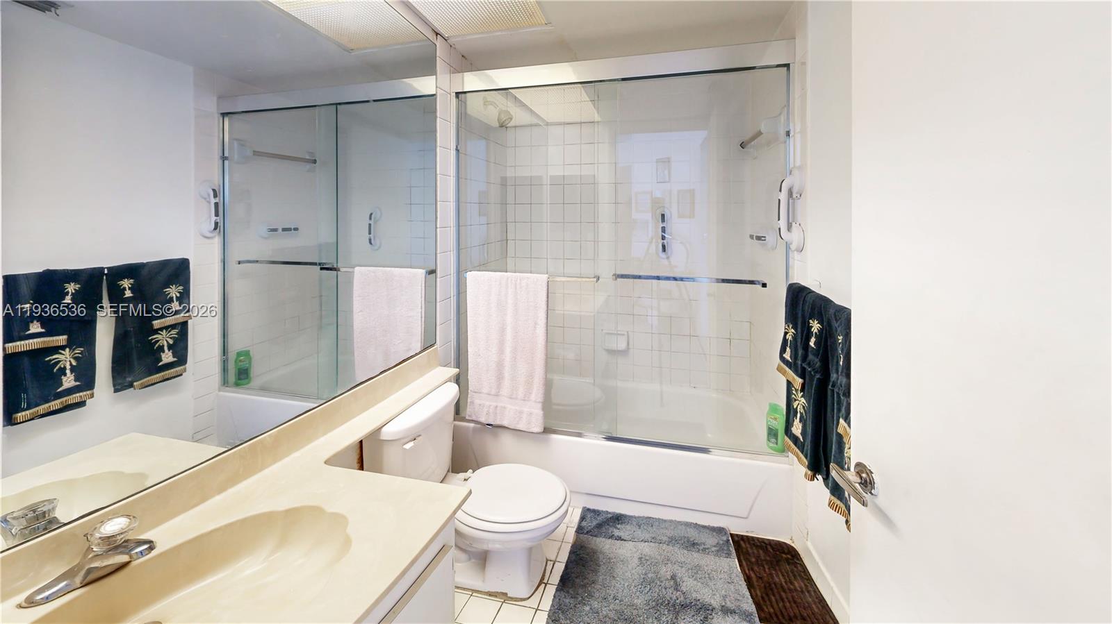 2657 Southeast 19th Court, Unit 103E Homestead, FL 33035 - Photo 24 of 50 a bathroom with a shower and a toilet