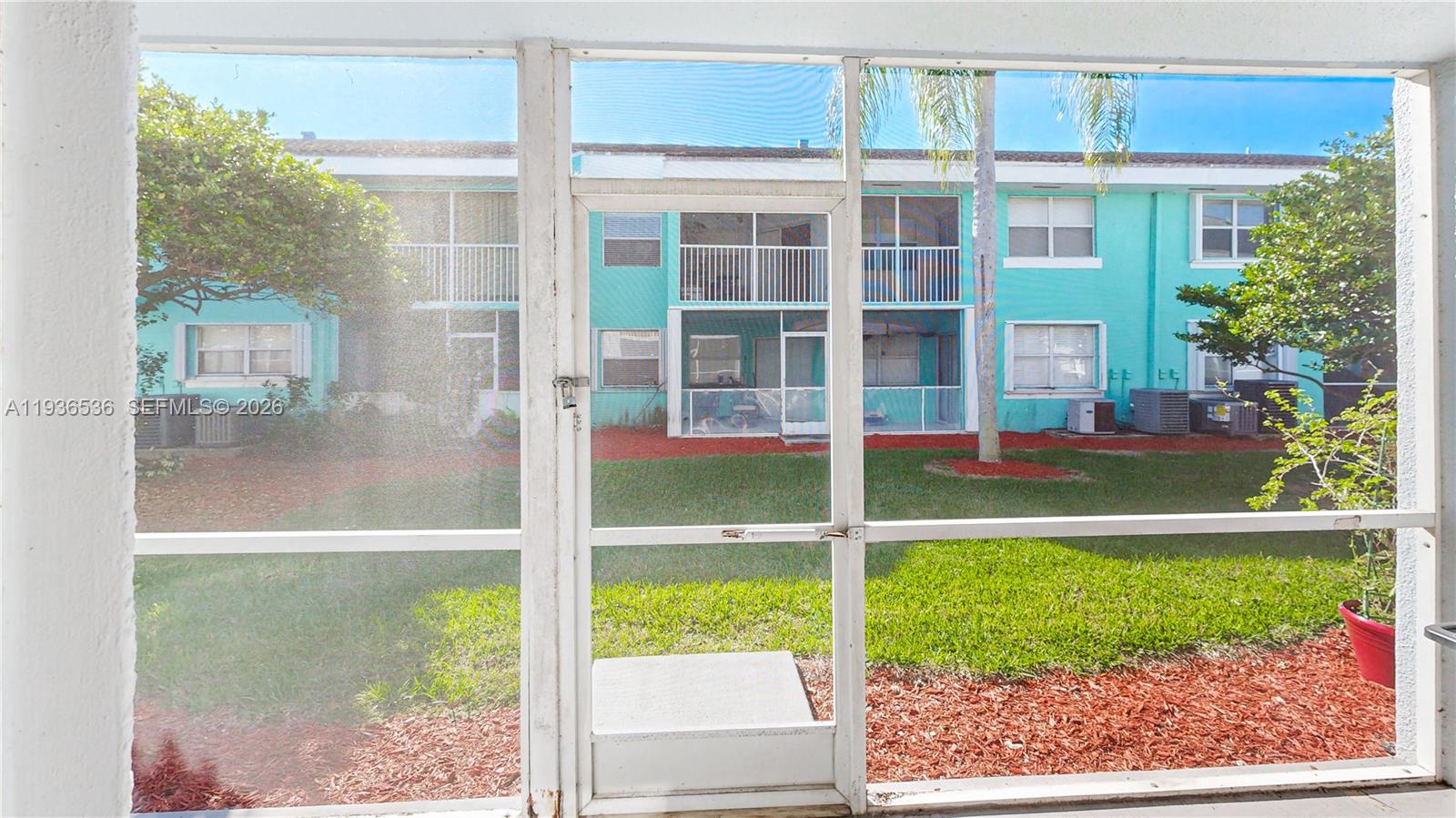 2657 Southeast 19th Court, Unit 103E Homestead, FL 33035 - Photo 25 of 50 a view of a house with a backyard
