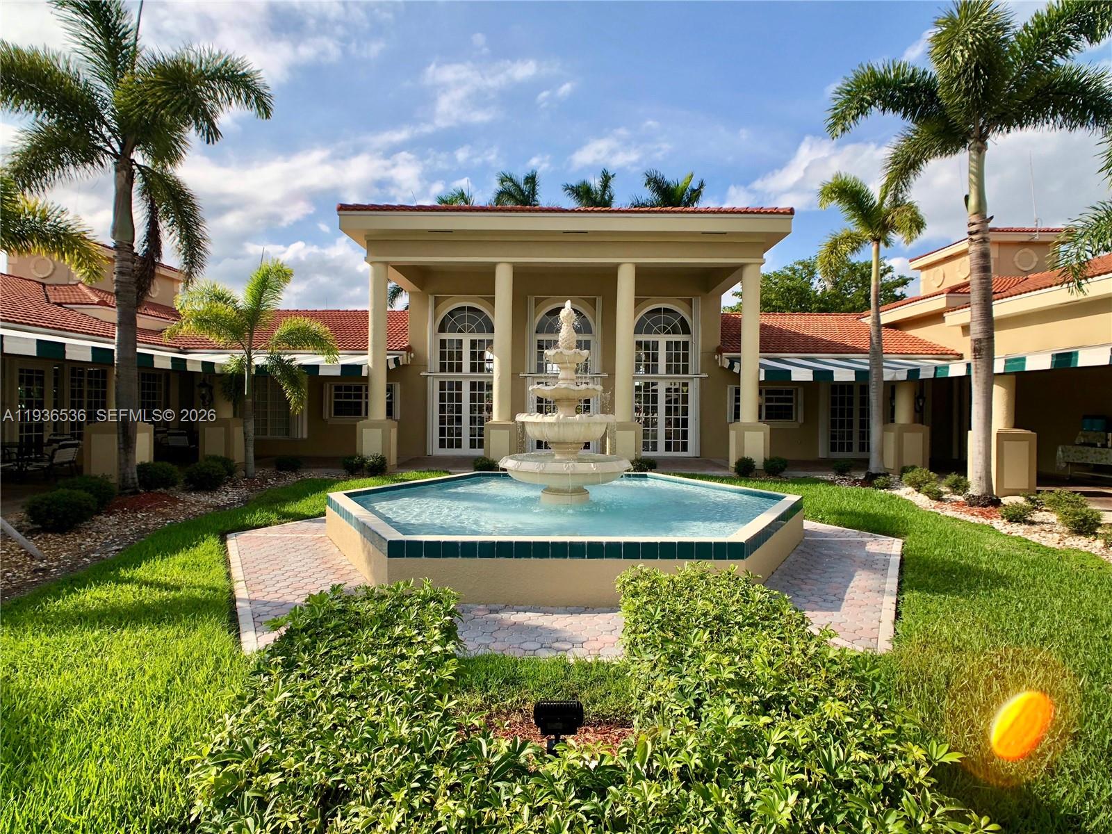 2657 Southeast 19th Court, Unit 103E Homestead, FL 33035 - Photo 40 of 50 a view of a house with fountain and a fountain