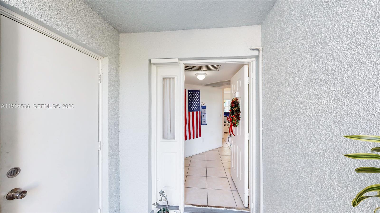 2657 Southeast 19th Court, Unit 103E Homestead, FL 33035 - Photo 4 of 50 a view of a hallway with elevator