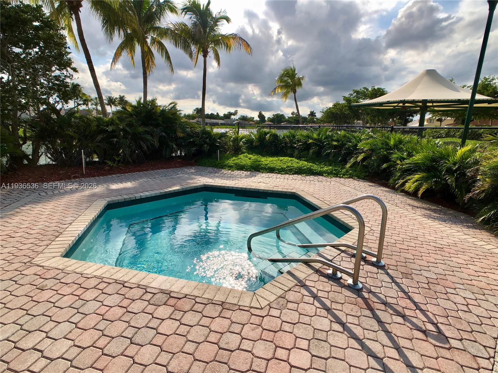 2657 Southeast 19th Court, Unit 103E Homestead, FL 33035 - Photo 41 of 50 a swimming pool with lawn chairs