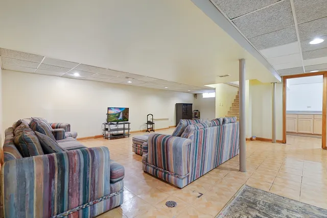 a living room with furniture a flat screen tv and a couch