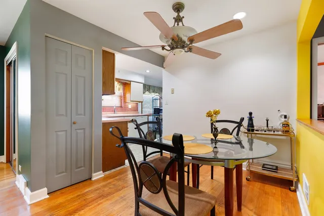 a view of a dining room with furniture and a chandelier