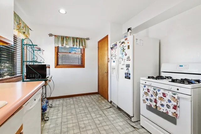 a kitchen with stainless steel appliances a stove a refrigerator and a refrigerator