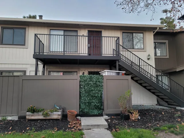 a view of backyard with wooden fence