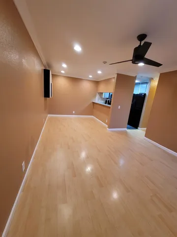 a view of kitchen with a refrigerator and a sink