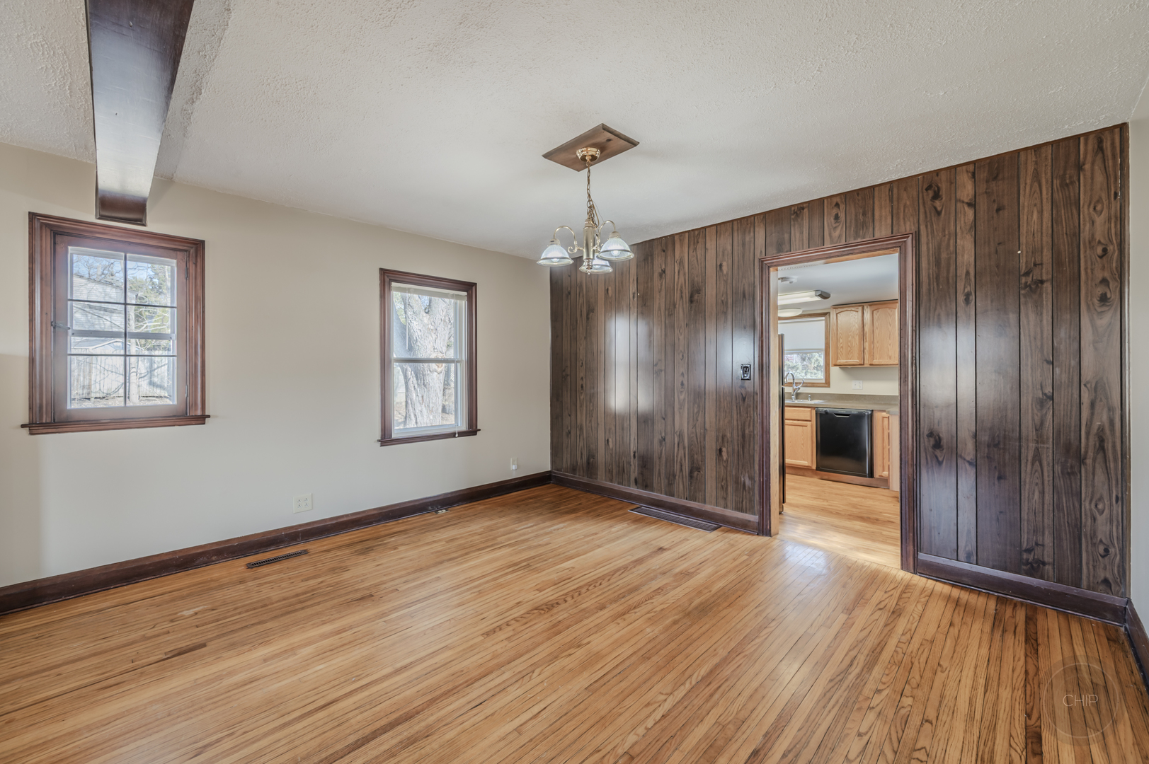 2240 State Rte 31 Oswego, IL 60543 - Photo 13 of 54 an empty room with wooden floor chandelier and windows