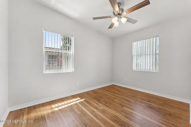 a bedroom with bed and a potted plant