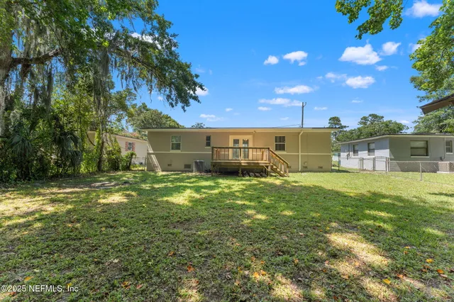 a view of a backyard with a garden and entertaining space