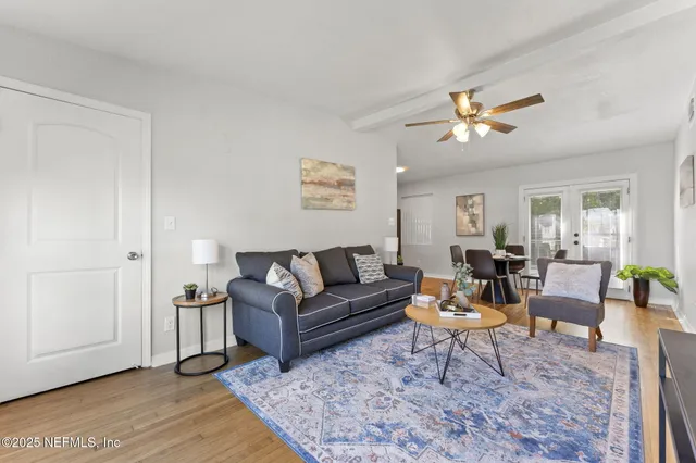 a living room with furniture a wooden floor and a table