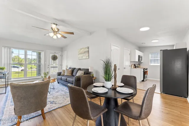 a view of a dining room with furniture window and wooden floor