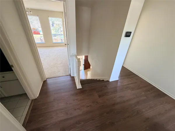 a view of an entryway with wooden floor