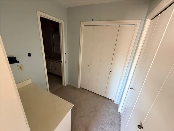 a view of a hallway with wooden floor and entryway