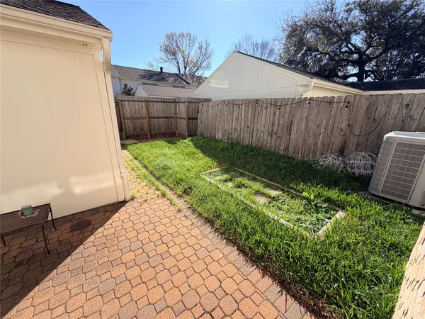 a view of a backyard with wooden fence