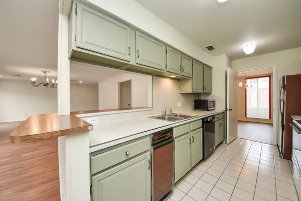 a kitchen with a sink cabinets and appliances
